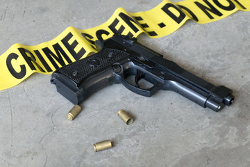 Crime scene concept black gun with casings
