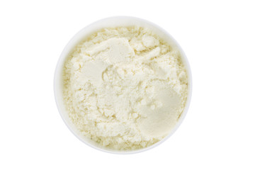 Closeup of powder milk in a white bowl. Top view.