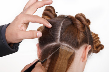 Natural Hair extensions at salon, closeup hands in hair