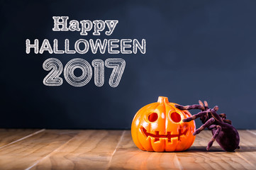 Happy Halloween 2017 message with pumpkin and spider on black background
