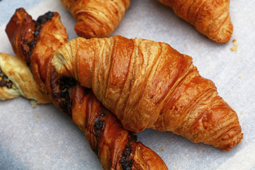 Freshly baked golden croissants close up