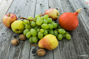 mix of fresh fruits, raw food ingredients. on wood background