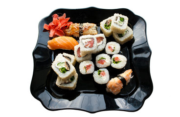 Japanese sushi on a black dish isolated. Close up
