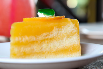 Orange cake on white plate.