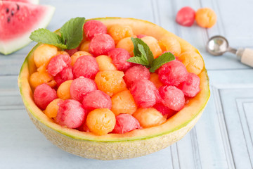 Colorful summer melon ball salad served in cantaloupe