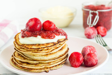 Pancakes with strawberry chia jam and vanilla cream, homemade and healthy snack.