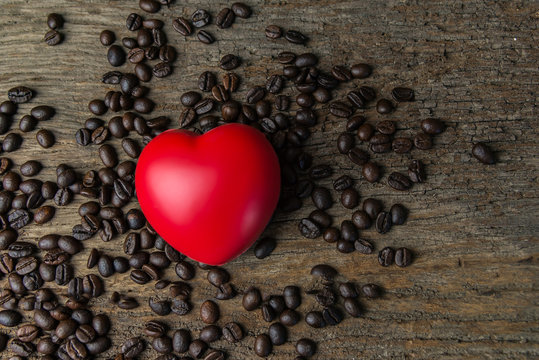 Red heart shape on coffee beans and dark background for valentine's day.