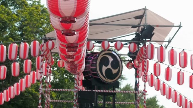 Japanese drum Taiko on the stage of the Yaguro. Paper red-white lanterns Chochin Scenery for the holiday Obon