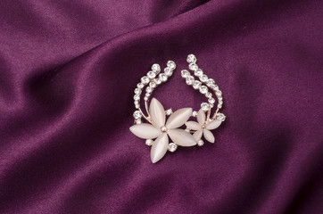Brooch flower with moonstone and diamonds on silk fabric