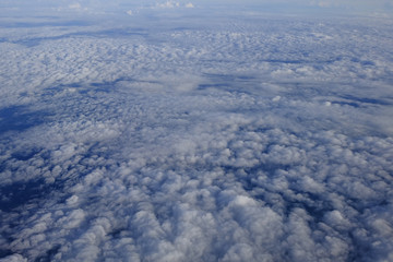 Flying above the clouds. view from the airplane, soft focus