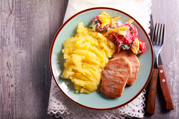 Fried pork chops, mashed potatoes and salad