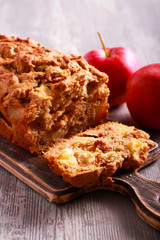 Apple and raisin cake, sliced on board
