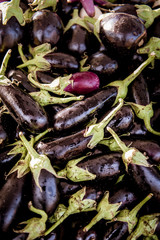 Eggplant fruits heap on market stall full frame high angle view