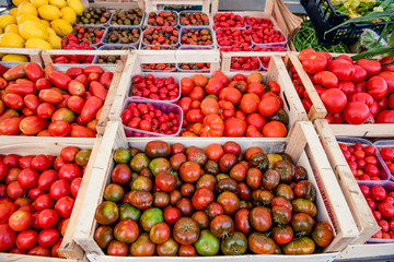 Many different tomato varieties heap on market stall
