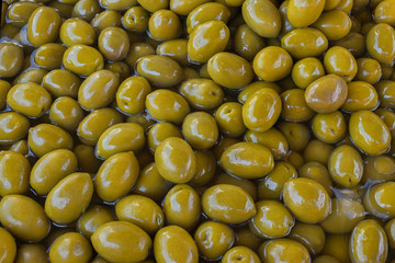 Green delicious marinated olives. Background. Texture. Greece.