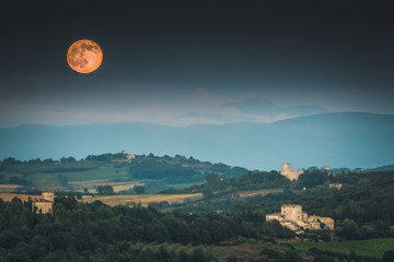 Full moon rising over Umbrian countryside in Italy © Elizabeth