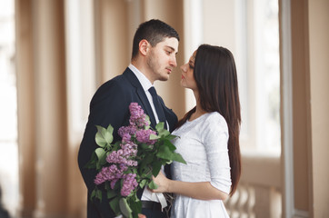 Beautiful couple, bride and groom posing near big white column