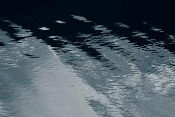 Surface of water and waves, dark tonality.