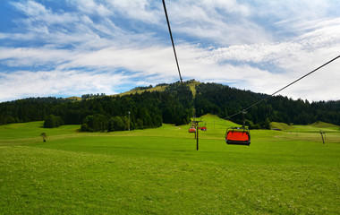 Obraz premium Chair lift transportation in Sankt Ulrich am Pillersee to Jakobskreuz Cross, Alps mountains, Austria