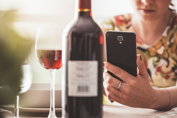 Woman using a wine app at the restaurant