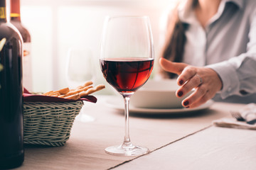 Woman tasting wine and having lunch