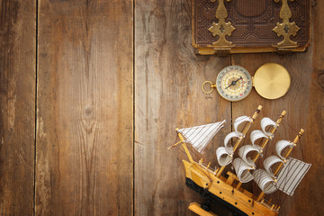 Columbus day concept with old ship over wooden background