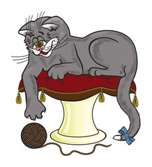 The cat lies on the pillow and is played with a ball of threads.