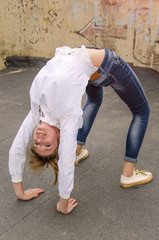 girl is engaged in gymnastics in the street