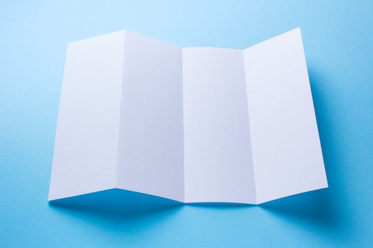 Leaflet blank Four-fold white paper brochure mockup on blue background