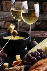 Gourmet Swiss fondue dinner on a winter evening with assorted ch