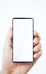 Hand holding white smartphone