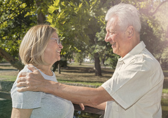 Happy smiling senior couple in park on sunny day. Healthy and Active Senior Living