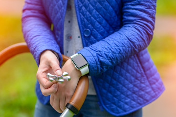 Girl playing with a Tri Fidget Hand Spinner outdoors in the park on walk with the child