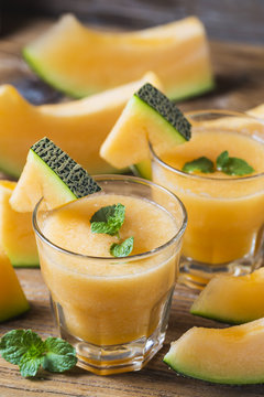 The juice of melon with mint in a glass jar on the table.Hami melon
