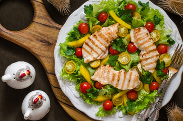 Salad with tomatoes sweet pepper chicken fillet and lemon dressing