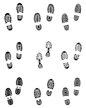 Various black prints of shoes on a white background