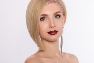 The lovely blonde with evening cosmetics on a face. Lips in style to an ombra and shooters in the...
