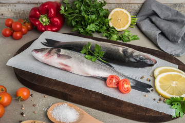 Fresh fish sea bass on wooden table