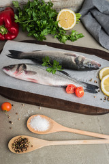 Fresh fish sea bass on wooden table