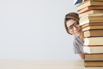 Happy student with a pile of books