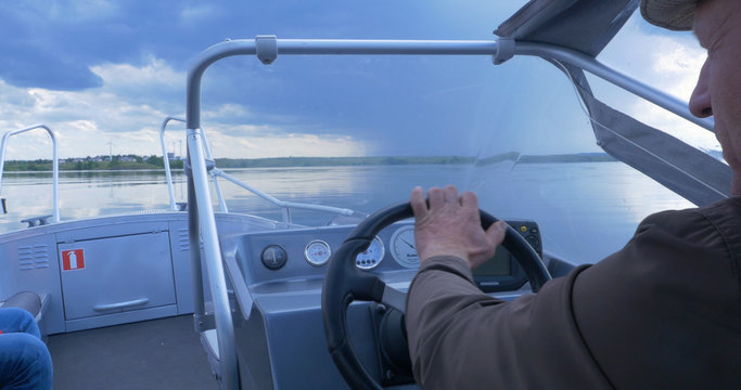 Old Man Driving A Fast Boat On The Lake