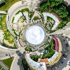 Aerial city view with crossroads and roads, houses, buildings, parks and parking lots, bridges. Helicopter drone shot. Wide Panoramic image.