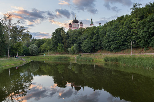 Domes of the monastery are reflected in the lake of Theophany Park. Kiev, Ukraine