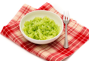 Grated fresh cucumber in white dish.