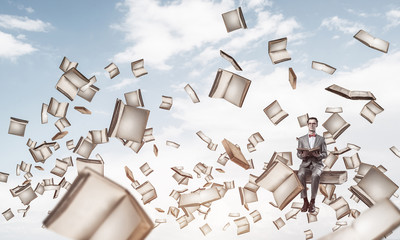 Young businessman or student studying the science and books fly 