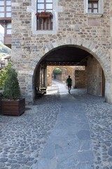 guy walking through the street in a stoned village, Potes, Spain