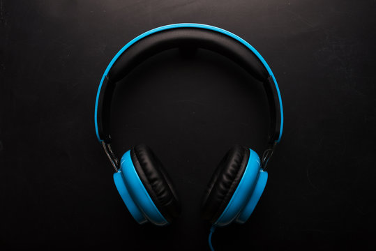 Blue headphones on black background