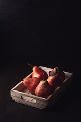 Ripe fresh pears in the wooden box. Organic fruits concept