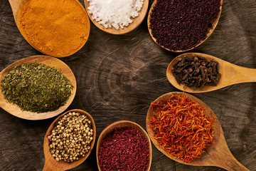 Assortment of indian spices and herbs in wooden spoon