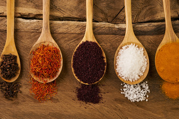 Wooden Spoon filled with various colorful spices